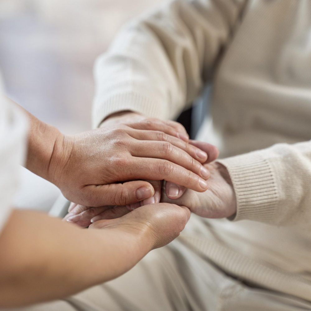 doctor-holding-hands-with-senior-patient